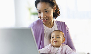 mom and baby looking at computer